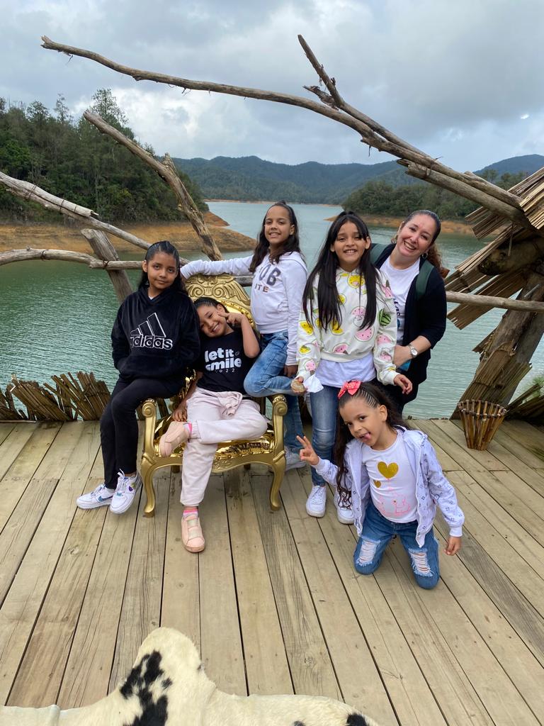 Olga, counselor at Casa de Sueños, and kids on a dock